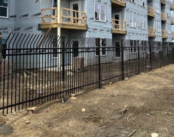 commercial-security-fence-installation Black commercial security fence installed at a construction site for safety and protection.