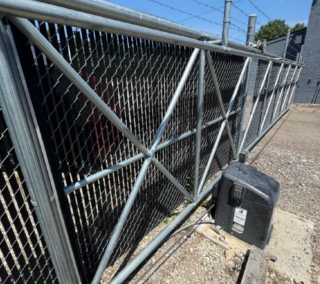 chain-link-cantilever-gate-with-operator-columbus Industrial chain link cantilever sliding gate with automatic gate operator installed for commercial property security.
